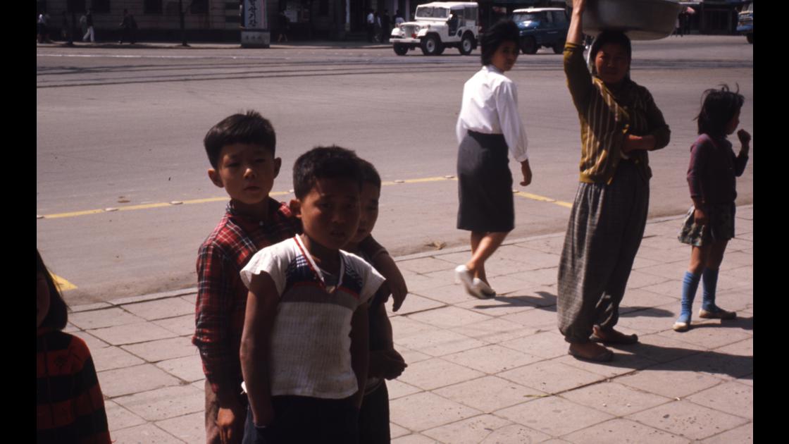 1966년 부산 중구 광복동 옛 부산시청 건너편 도로에서 카메라 촬영을 신기한 듯 바라보는 소년들 썸네일